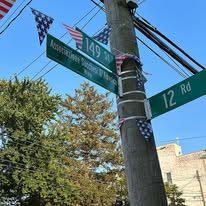 The Associazione Sacchesi D'America Way street sign installed on the corner of 149th Street and 12th Road, Whitestone